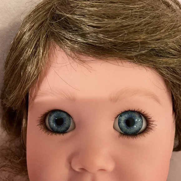 Adorable Baby Doll with Blue Eyes and Pink Outfit - Picture 6 of 7